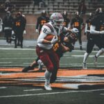 Intense high school football game showcasing action and teamwork on the field.